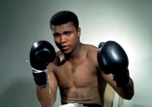 Muhammad Ali poses with his boxing gloves. Action Images/Sporting Pictures