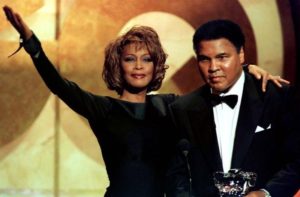 Muhammad Ali is given the Courage Award by singer Whitney Houston at the GQ Men of the Year awards show, October 1998. REUTERS/Jeff Christensen