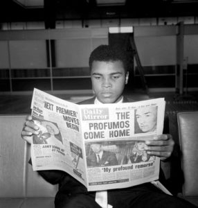 Muhammad Ali reads the newspapers in London the day after his World Title Fight win against Henry Cooper, June 1963. Action Images / MSI