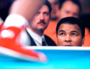 Former world heavyweight boxing champion Muhammad Ali watches his 21-year-old daughter Laila Ali in her debut as a professional boxer at the Turning Stone Casino in Verona, in this October 8, 1999 file photo. REUTERS/Joe Traver/File Photo