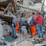 Rescuers works after a quake hit Amatrice