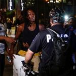 People shout at the police in uptown Charlotte, NC during a protest of the police shooting of Keith Scott, in Charlotte