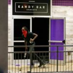A looter grabs liquor bottles from the club Kandy Bar in uptown Charlotte, NC during a protest of the police shooting of Keith Scott, in Charlotte
