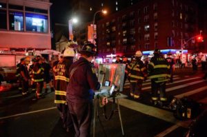 New York City police and firefighters stand near the site of an explosion in the Chelsea neighborhood of Manhattan, New York, U.S. September 17, 2016. REUTERS/Rashid Umar Abbasi
