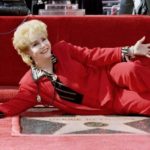 FILE PHOTO: Actress Debbie Reynolds poses atop her newly unveiled star in the live theatre and stage