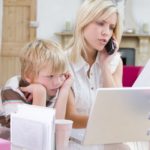 woman-using-telephone-in-home-office-with-laptop-while-young-boy-waits_HF8_gnArs