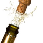 freepik/Close up of champagne cork popping on white background