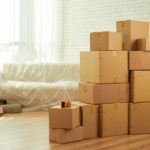 freepik/shot-room-interior-with-package-boxes-standing-middle-sofa-covered-with-film_1098-20802
