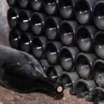 freepik/ancient-bottoms-old-dusty-wine-bottles-rows-cellar-winery_128384-422