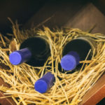 freepik/old-wine-bottles-wooden-box-with-straw_97889-91