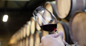 https://www.freepik.com/premium-photo/closeup-hand-with-glass-red-wine-background-wooden-oak-barrels-stacked-straight-rows-order-old-cellar-winery_5426986.htm#query=wine%20store&position=14