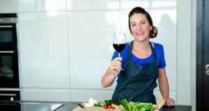 https://www.freepik.com/premium-photo/smiling-woman-kitchen-preparing-vegetables-drinking-red-wine_5419159.htm