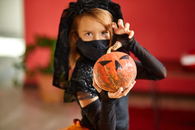 https://www.freepik.com/premium-photo/girl-home-halloween-costume-with-pumkin-jack-laurent-hands-child-wearing-black-face-mask-protecting-from-coronavirus-halloween-quarantine_10657645.htm#page=1&query=covid%20trick%20or%20treat&position=5