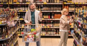 https://www.freepik.com/premium-photo/mature-bearded-man-with-shopping-cart-choosing-bottle-cognac-by-shelf-alcohol-department-while-his-wife-taking-champagne_11344426.htm