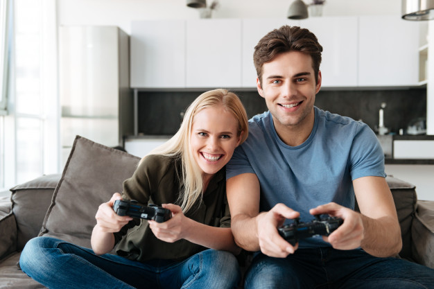 https://www.freepik.com/free-photo/happy-lovers-looking-camera-while-playing-video-games-home_6812721.htm