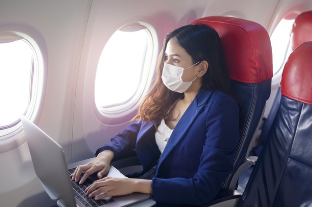 https://www.freepik.com/premium-photo/young-businesswoman-wearing-face-mask-is-using-laptop-onboard-new-normal-travel-after-covid-19-pandemic-concept_10098992.htm#page=2&query=covid+flying&position=18
