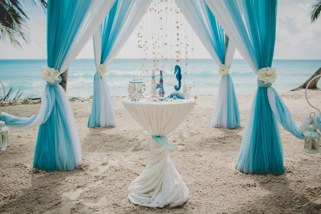 https://www.freepik.com/free-photo/blue-white-wedding-aisle-beach-surrounded-by-palms-with-sea-background_13499592.htm#page=1&query=beach+wedding&position=3