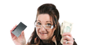 https://www.storyblocks.com/images/stock/brunette-woman-holding-up-a-blank-credit-card-business-card-shoppers-club-card-or-gift-card-of-some-sort-along-with-some-cash-in-her-other-hand-stqgbpcroiskjq8v2