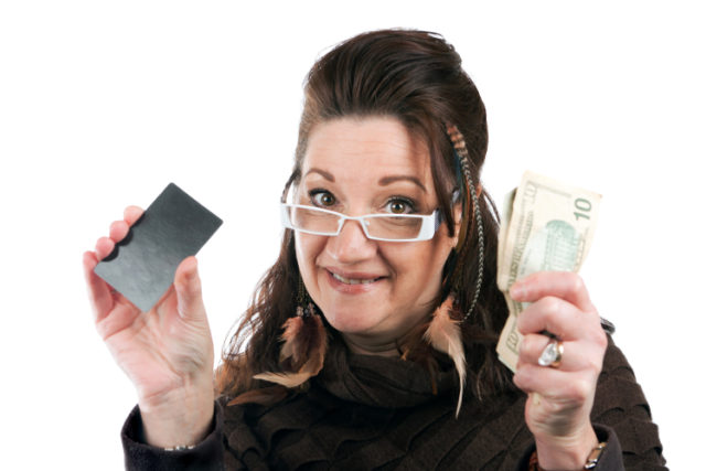 https://www.storyblocks.com/images/stock/brunette-woman-holding-up-a-blank-credit-card-business-card-shoppers-club-card-or-gift-card-of-some-sort-along-with-some-cash-in-her-other-hand-stqgbpcroiskjq8v2
