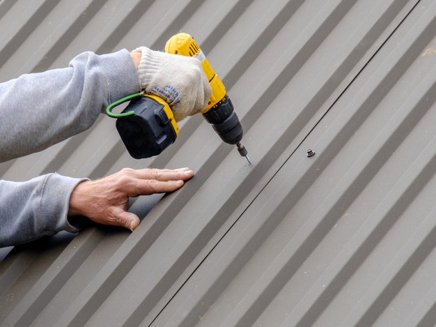 https://www.freepik.com/premium-photo/male-hands-gloves-with-screwdriver-screw-roofing-sheet-roof_14700689.htm?query=metal%20roof