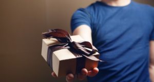 https://www.freepik.com/premium-photo/man-holding-gift-box-his-hand-brown-background_14529448.htm?query=pile%20of%20gifts