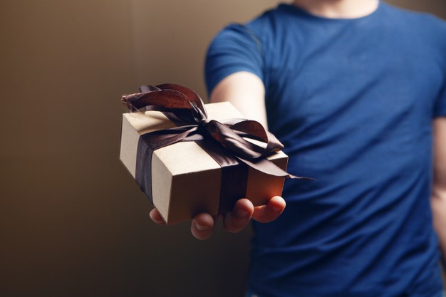 https://www.freepik.com/premium-photo/man-holding-gift-box-his-hand-brown-background_14529448.htm?query=pile%20of%20gifts
