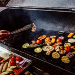 man-fries-grilled-vegetables-with-sausages_140725-9188