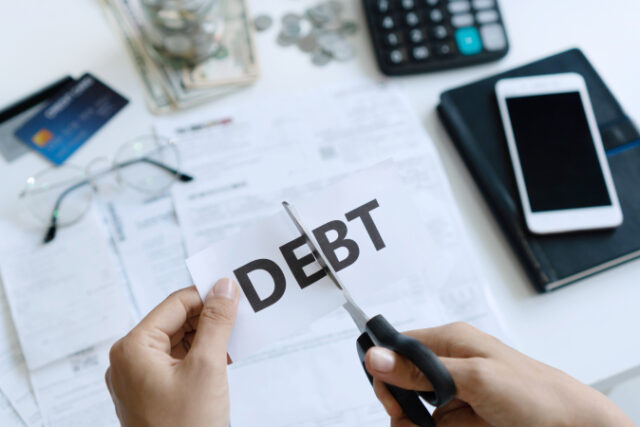 https://www.freepik.com/premium-photo/top-view-woman-hands-cutting-paper-with-word-debt-written-it_7749655.htm#page=1&query=debt&position=26