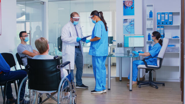 https://www.freepik.com/free-photo/doctor-with-face-mask-against-covid19-discussing-with-nurse-hospital-waiting-area-disabled-senior-woman-wheelchair-waiting-examination-assistant-working-reception-computer_16166494.htm#page=1&query=office%20nurse&position=3&from_view=search
