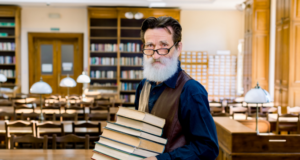 https://www.freepik.com/premium-photo/confident-elegant-librarian-university-professor-teacher-man-wearing-stylish-clothes-happy-share-knowledge-holding-stack-different-books-standing-vintage-library-indoors_9140703.htm#query=elderly%20librarian&position=20&from_view=search