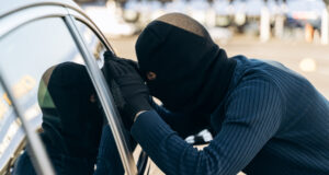 https://www.vecteezy.com/photo/3492195-man-dressed-in-black-with-a-balaclava-on-his-head-looking-at-the-glass-of-car-before-the-stealing-car-thief-car-theft-concept