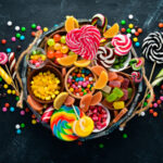 colorful-candies-jelly-marmalade-wooden-box-sweets-old-background-top-view-free-copy-space