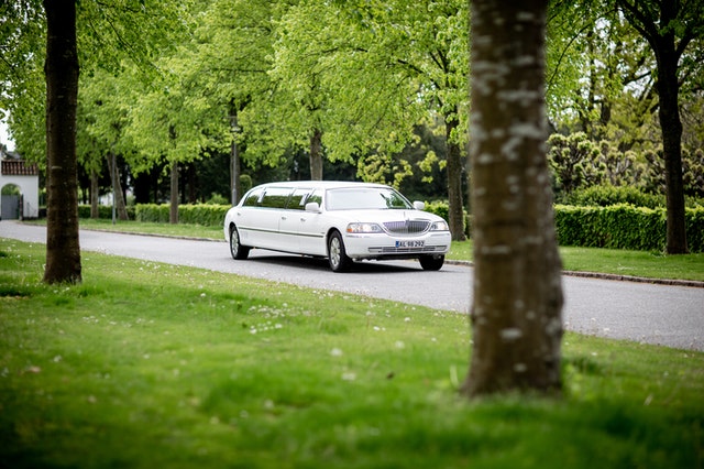 https://www.pexels.com/photo/white-limousine-driving-on-road-2504936/