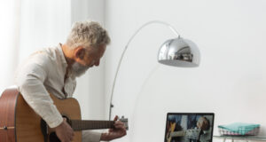 https://www.freepik.com/premium-photo/senior-man-home-studying-guitar-lessons-laptop_15030745.htm?query=music%20teacher
