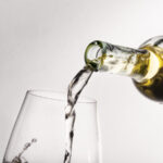 close-up-bottle-pouring-wine-into-glass