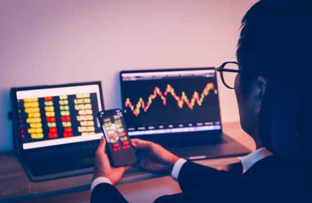 https://www.vecteezy.com/photo/7311896-businessman-using-cell-phone-with-statistic-graph-of-stock-market-analysis-on-laptop-screen-and-technology
