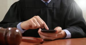 https://www.vecteezy.com/photo/5319938-justice-and-law-concept-male-judge-in-a-courtroom-with-the-gavel-working-with-smart-phone-computer-on-wood-table