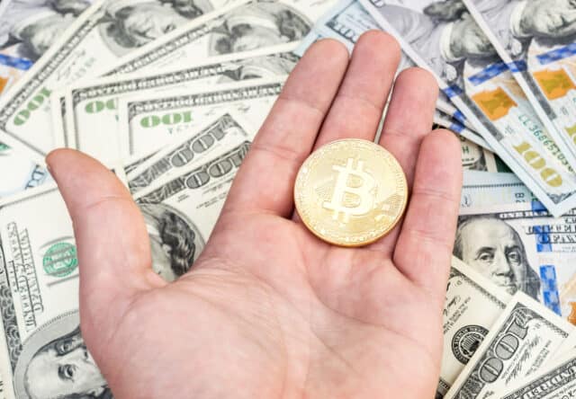 https://www.freepik.com/premium-photo/man-s-hand-holding-golden-bitcoin-background-us-dollars_29643450.htm#page=2&query=bitcoin&position=12&from_view=search