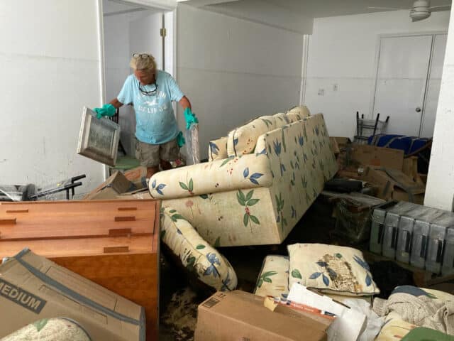 Resident Pamela Brislin who has lived on Sanibel Island since 2020 cleans up the damage from Hurricane Ian, Thursday, Oct. 6, 2022, in Sanibel Island, Fla. Residents of Florida’s Gulf Coast barrier islands are returning to assess the damage from Hurricane Ian, despite limited access to some areas. (AP Photo/Scott Smith)