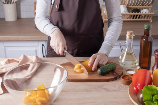 https://www.vecteezy.com/photo/12875777-a-young-girl-cuts-yellow-fresh-pepper-on-a-cutting-board-cooking-vegetable-salad-in-the-kitchen-at-home