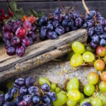 sprig of grapes on wooden background