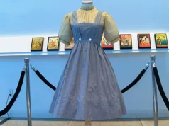 A blue and white checked gingham dress, worn by Judy Garland in the “Wizard of Oz,” hangs on display, Monday, April 25, 2022, at Bonhams in New York. Katie Vasquez | AP